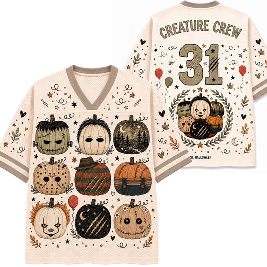 A cream-colored V-neck t-shirt shown from both the front and back, featuring a spooky Halloween theme with illustrated pumpkins, stars, leaves, and the text 'CREATURE CREW 31' and 'Halloween'.