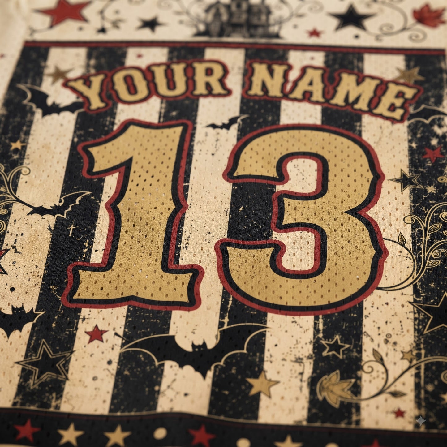 Close-up of a personalized sports jersey design with the text 'YOUR NAME' and the number '13' in a distressed black-and-cream striped pattern with red outlines and decorative stars.