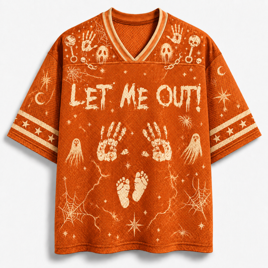 An orange short-sleeve V-neck t-shirt with a distressed cream-colored Halloween graphic print featuring the text 'LET ME OUT!' along with handprints, ghosts, stars, and footprints.
