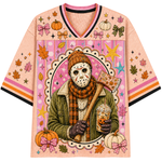 A short-sleeve V-neck t-shirt with a detailed Halloween graphic print. The design features a central character in a hockey mask holding a pumpkin-themed drink and an axe, surrounded by pumpkins, autumn leaves, stars, and bows on a pink patterned background, all set against a solid white backdrop.