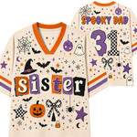 A Halloween-themed sports jersey shown from both front and back. The cream-colored jersey features orange trim, purple and orange lettering spelling 'Sister' and 'Spooky Dad', a large purple number 31, and various spooky illustrations including bats, ghosts, spiders, stars, and a pumpkin.