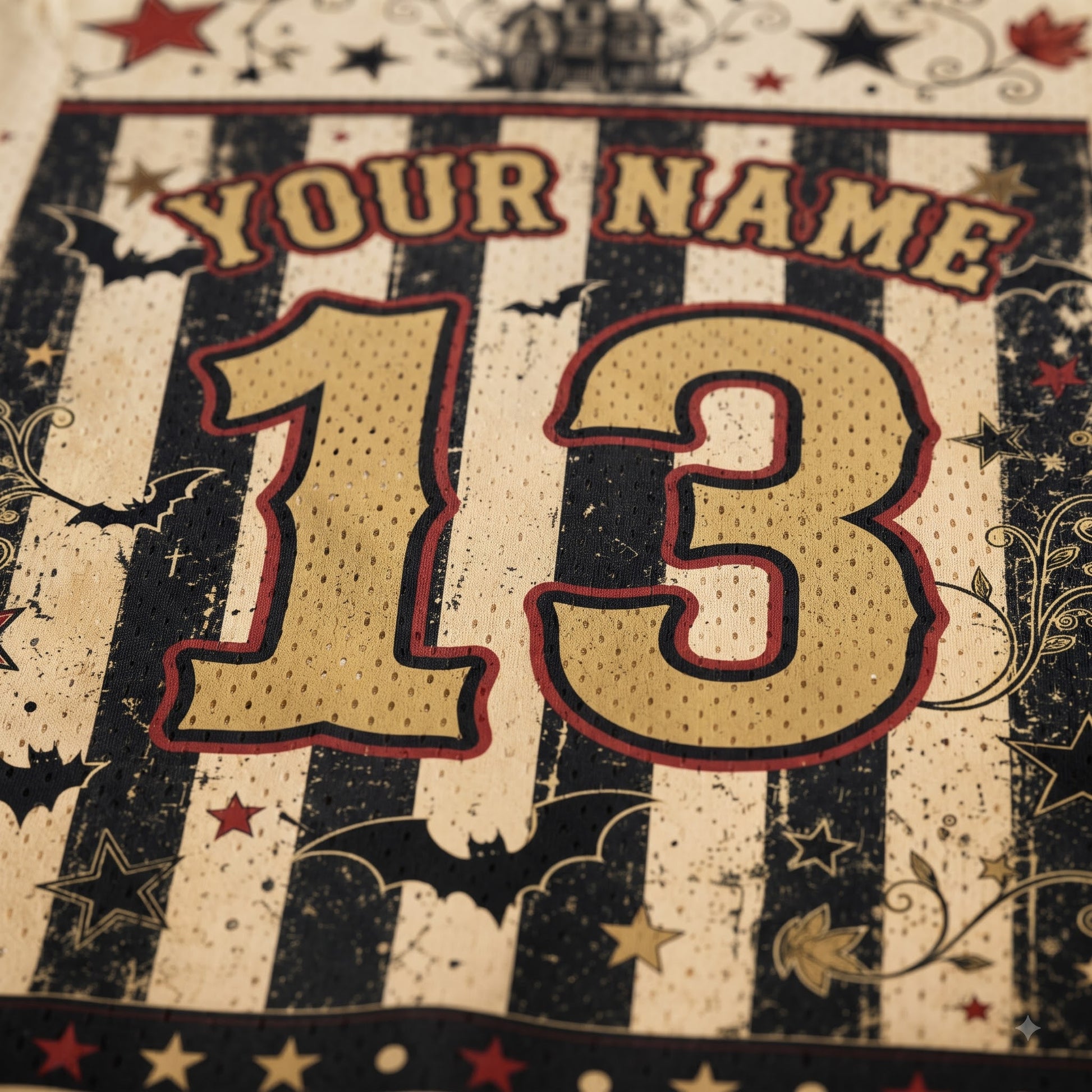 Close-up of a personalized sports jersey design with the text 'YOUR NAME' and the number '13' in a distressed black-and-cream striped pattern with red outlines and decorative stars.