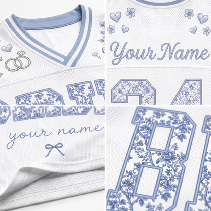 White mesh athletic jersey with light blue trim and blue floral print details, shown in a three-panel close-up collage. The panels highlight the collar, customizable script text reading 'Your Name' with floral accents, and large floral-number lettering.