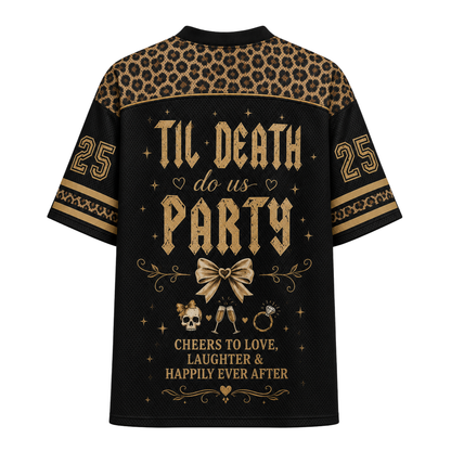 A black short-sleeve t-shirt with a gold graphic print on the back. The design features a leopard print pattern across the shoulders, gold gothic text reading 'TIL DEATH do us PARTY' in the center, a gold bow illustration, a small skull and glasses graphic, and the number '25' on both sleeves.