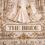 A close-up of a printed textile or fabric design featuring an illustration of a bride's flowing gown in a forest scene, with the words 'THE BRIDE' in a decorative panel and floral border details.