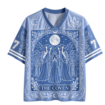 A blue and white short-sleeve V-neck t-shirt featuring a 'The Coven' tarot card design with a full moon, coven figures, and ornate celestial patterns.