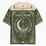 A short-sleeve graphic T-shirt shown from the back, featuring a dark brown and black Halloween-themed design with the words 'TRAPPED SPIRIT,' a large cracked beige number 13, ghosts, stars, moons, footprints, and spiderwebs. The shirt is photographed on a plain light background.
