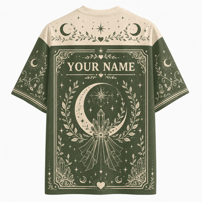 A short-sleeve graphic T-shirt shown from the back, featuring a dark brown and black Halloween-themed design with the words 'TRAPPED SPIRIT,' a large cracked beige number 13, ghosts, stars, moons, footprints, and spiderwebs. The shirt is photographed on a plain light background.