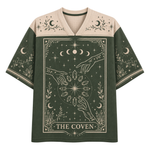 A short-sleeve V-neck t-shirt with a Halloween theme, featuring the text 'LET ME OUT!' in distressed white letters over a dark brown and black background with handprints, skulls, ghosts, and stars.