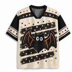 A short-sleeve V-neck t-shirt with a Halloween theme, featuring a large black bat graphic with orange wings on a cream background with black and orange polka dot stripes.