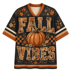 A short-sleeve V-neck t-shirt with a fall-themed graphic print. The shirt features a large orange pumpkin in the center, surrounded by the words 'FALL VIBES' in a distressed, rustic orange and beige font.