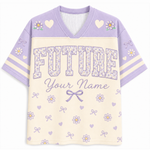 A short-sleeve V-neck athletic-style shirt in lavender and cream, featuring floral and heart motifs, striped sleeves, and the word 'FUTURE' with the text 'Your Name' on the front.