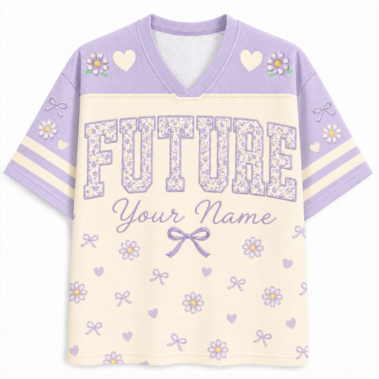A short-sleeve V-neck athletic-style shirt in lavender and cream, featuring floral and heart motifs, striped sleeves, and the word 'FUTURE' with the text 'Your Name' on the front.