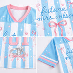 A light blue and white striped V-neck jersey-style top with pink trim, shown in a four-panel collage. The fabric features pink bows, stars, hearts, and script text reading 'future Mrs.