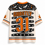 A Halloween-themed short-sleeve jersey shown from the back, featuring 'GHASTLY 31' in orange text and numbers on an off-white background, with black and orange holiday graphics including bats, stars, and pumpkins.