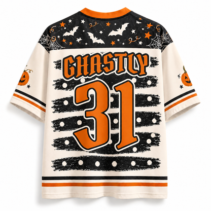 A Halloween-themed short-sleeve jersey shown from the back, featuring 'GHASTLY 31' in orange text and numbers on an off-white background, with black and orange holiday graphics including bats, stars, and pumpkins.