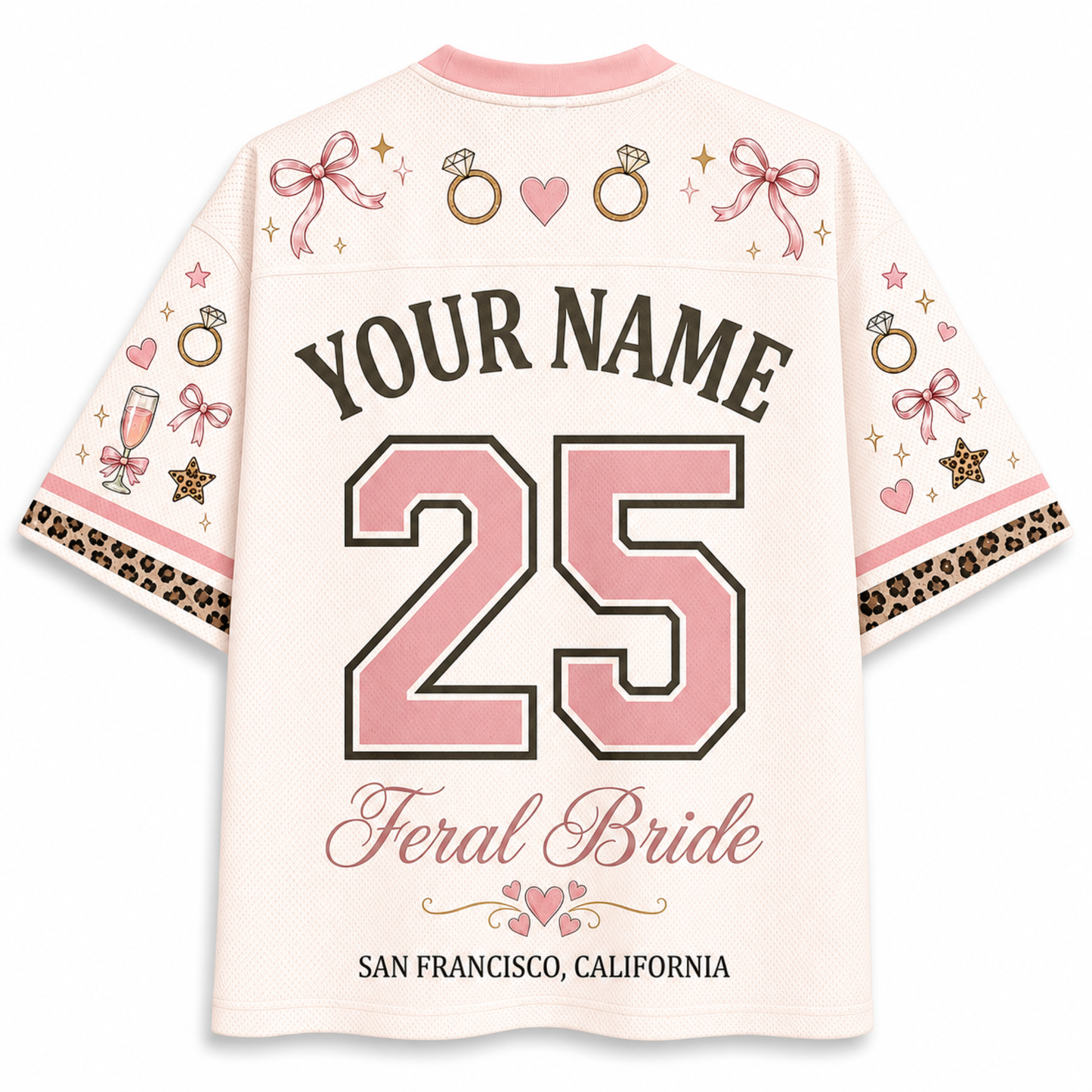 A custom short-sleeve t-shirt shown from the back, featuring a light pink base with a variety of bridal-themed graphics including pink bows, engagement rings, hearts, champagne glasses, and leopard print cuffs. The shirt is personalized with the text 'YOUR NAME', the number '25' in pink, 'Feral Bride', and 'SAN FRANCISCO, CALIFORNIA'.