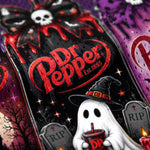 A close-up of a Dr. Pepper bottle with a Halloween-themed label featuring a ghost in a witch hat, tombstones, stars, bats, and red dripping graphics on a dark background.