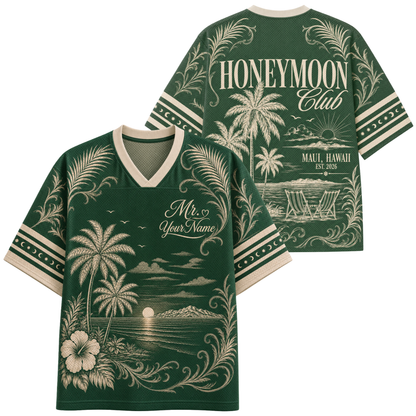 A dark green short-sleeve V-neck t-shirt with cream-colored tropical graphics, shown in both front and back views. The back features 'HONEYMOON Club' and 'MAUI, HAWAII EST.