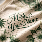 Close-up of a cream-colored mesh fabric with green tropical floral print and the text 'Mrs. Your Name' in dark green script.
