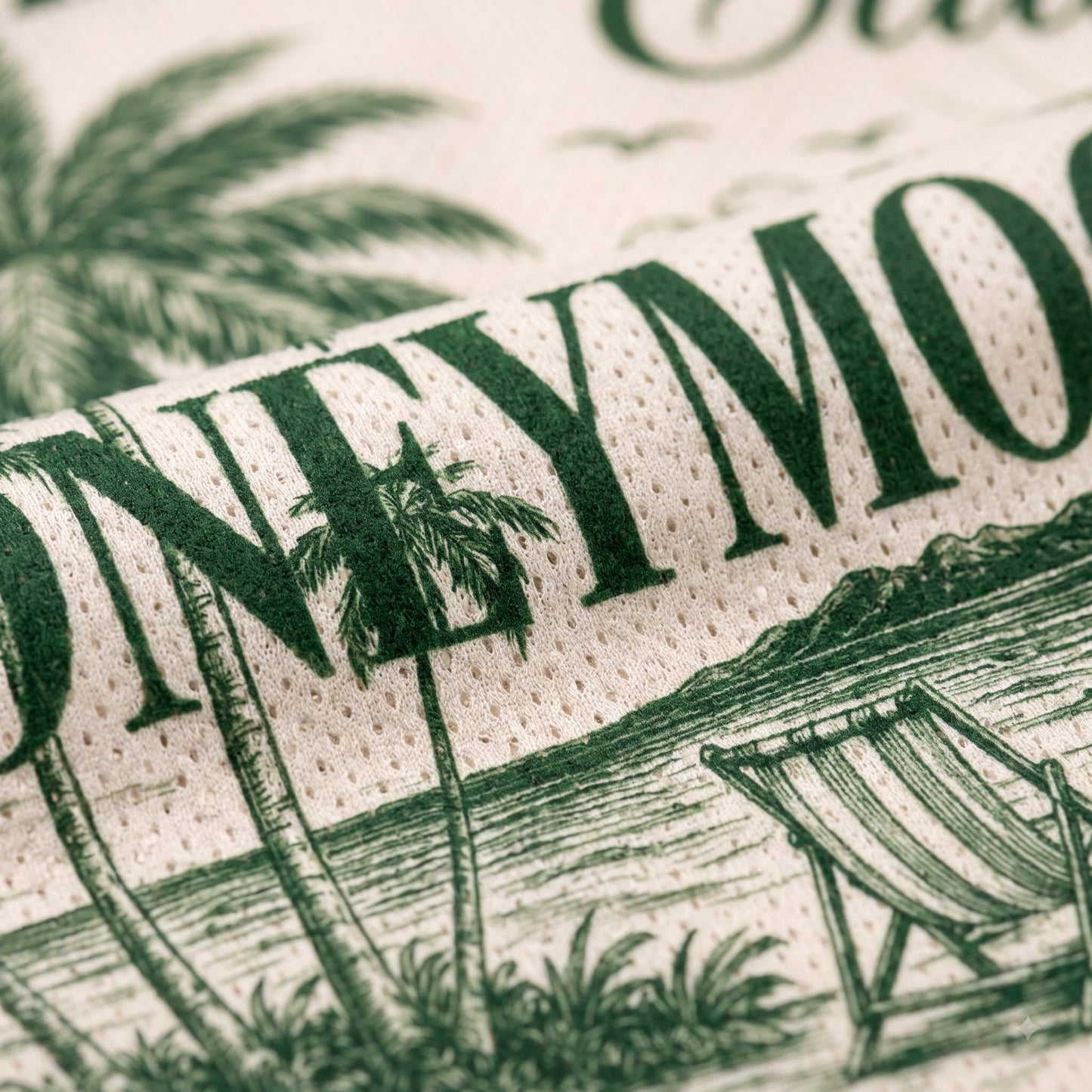 Close-up of a rolled fabric or napkin with a tropical beach print. The design features dark green text reading 'HONEYMOON' alongside illustrations of palm trees, a beach chair, and ocean scenery on a warm cream background.
