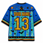 Customizable short-sleeve athletic jersey shown from the back, featuring a blue and teal striped design with a distressed grunge texture, decorated with Halloween motifs including bats, stars, and a haunted house. The back displays 'YOUR NAME' and the number '13' in large gold lettering.