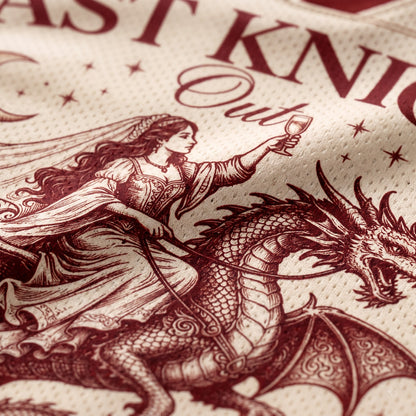 Close-up of a printed textile featuring a dark burgundy illustration of a knight in armor with a sword and a dragon, alongside partial text reading 'Knight Out' on a textured cream fabric background.
