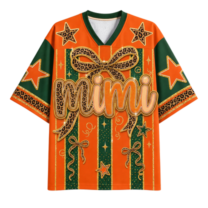 Orange and green graphic t-shirt with leopard print bow and star details, featuring the word 'mimi' across the front.