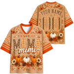 A personalized fall-themed short-sleeve V-neck jersey shirt shown from both front and back. The base color is a warm tan/beige, decorated with orange stripes, orange and brown leopard print lettering, white pumpkins, pinecones, and autumn flowers.
