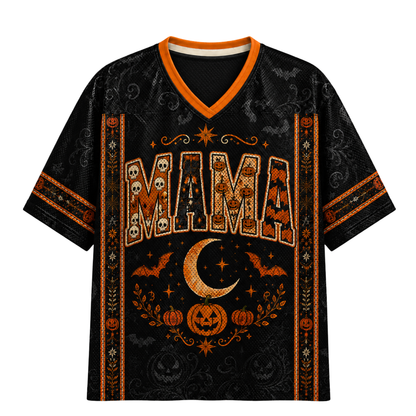 A black short-sleeve V-neck t-shirt with an orange and white Halloween-themed graphic print featuring the word 'MAMA' in skull-filled letters, a crescent moon, pumpkins, and bats.