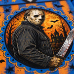 A Halloween-themed graphic print featuring a masked figure in a dark jacket holding a blood-stained knife, set against a haunted house and bats at night. The artwork is framed by a blue and orange patterned border with stars and decorative scalloped edges.