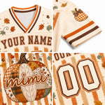 A four-panel collage showing a customizable autumn-themed sports jersey. The jersey has a cream mesh base with orange and brown striped trim, a patchwork pumpkin design, fall leaves, and customizable text reading 'YOUR NAME' and number '00'.