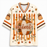 A cream-colored mesh V-neck jersey with an all-over autumn theme, featuring a large patchwork pumpkin with the word 'mimi' across the center, orange and brown vertical stripes, scattered fall leaves, and gingham pumpkin motifs on the sleeves.