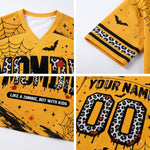A yellow V-neck t-shirt with a Halloween zombie theme, shown in a four-panel collage highlighting details: the front graphic with 'ZOMBIE' in leopard print, a sleeve with black stripes and leopard print, the front text 'LIKE A ZOMBIE, BUT WITH KIDS', and a customizable back graphic with 'YOUR NAME' and leopard print numbers '00'.