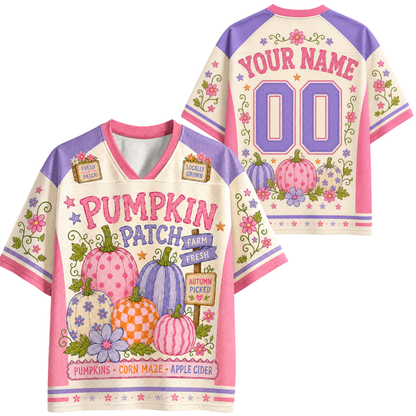 A short-sleeve V-neck graphic T-shirt shown from both front and back on a plain white background. The shirt has a cream base with pink and purple trim, floral and pumpkin illustrations, and customizable text reading 'YOUR NAME' and '00' on the back.