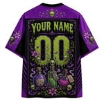 A purple and black short-sleeve t-shirt with a large gothic-themed graphic on the back. The design features a customizable name and number placeholder, surrounded by skulls, purple flowers, potion bottles, and bats.