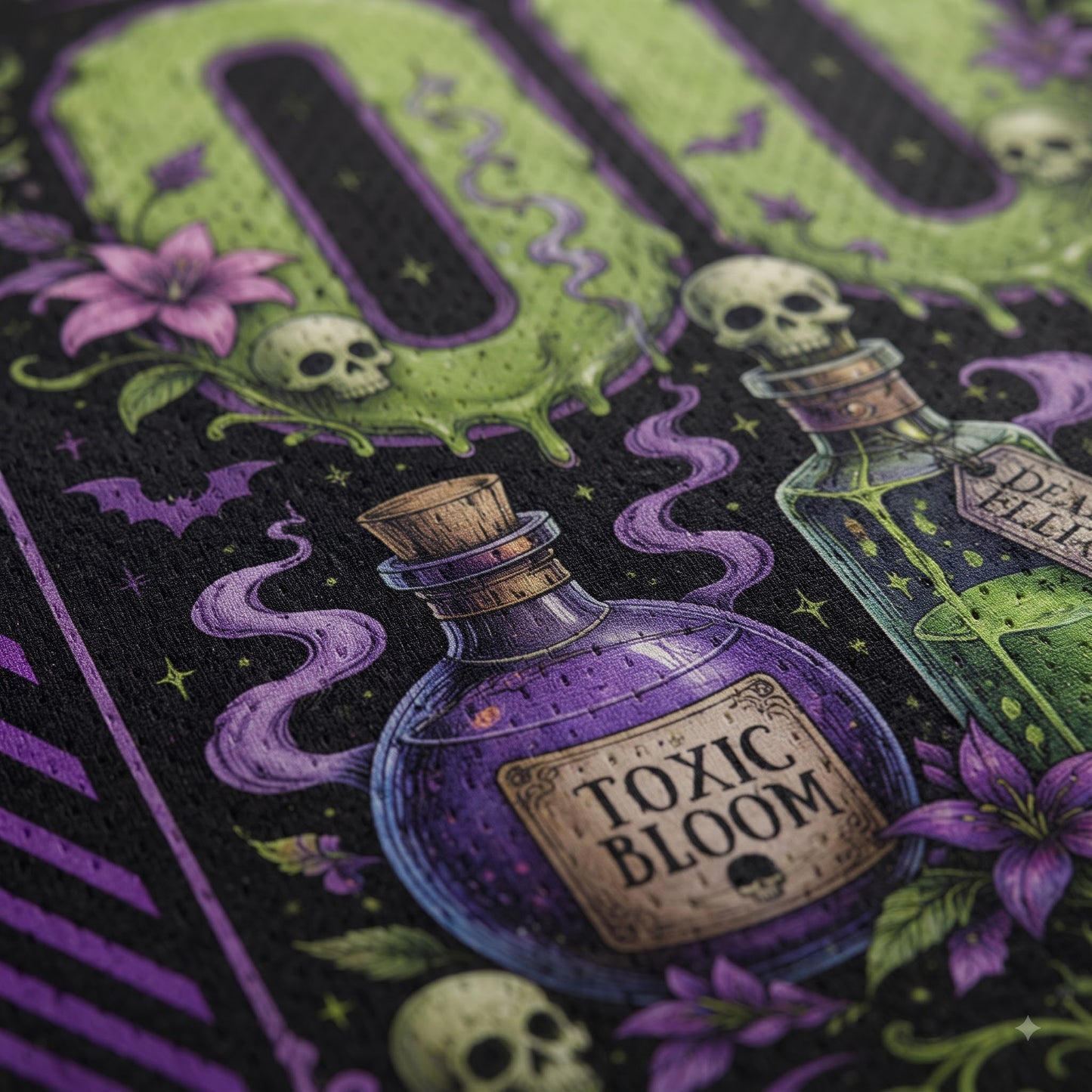 Close-up of a Halloween-themed graphic print featuring two glass potion bottles labeled 'Toxic Bloom' and 'Deadly Dose', skulls, flowers, bats, and a green dripping 'DO NOT' design on a black background.
