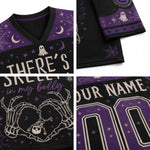 A four-panel close-up collage of a Halloween-themed V-neck jersey. The jersey is black with purple panels, featuring skeleton hands forming a heart, a skeleton baby, a ghost, spiderwebs, stars, and text reading 'THERE'S SKELLET in my belly' and 'YOUR NAME'.