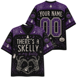 A black and purple Halloween-themed V-neck t-shirt shown from both the front and back. The front features the text 'THERE'S A SKELLY in my belly' with skeleton hands forming a heart, while the back displays 'YOUR NAME' and '00' for personalization.