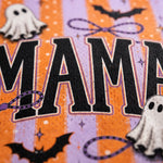 Close-up of a Halloween-themed printed surface with large black letters outlined in white, orange and lavender stripes, ghost cutouts, bats, and purple rope details.