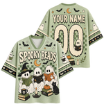A light sage green short-sleeve V-neck t-shirt with Halloween-themed graphics, shown in both front and back views. The front features 'Spooky Reads' text with three cartoon ghosts reading books, a pumpkin, a black cat, and a candle.