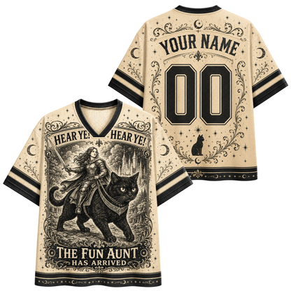 Front and back views of a beige V-neck jersey-style shirt with black trim, featuring a vintage-style witch riding a black cat illustration on the front and customizable text 'YOUR NAME' and '00' on the back.