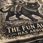 Close-up of a vintage-style illustrated print showing a black cat carrying a rider, with ornate decorative scrollwork and the partial text 'THE FUN AL.