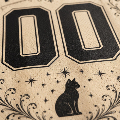Close-up of a beige printed surface with large black '00' numerals, a black cat silhouette, star motifs, and decorative flourishes.