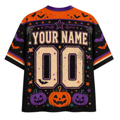 A Halloween-themed short-sleeve t-shirt with a black body, orange shoulders, and purple and orange accents. The back of the shirt features a customizable design with 'YOUR NAME' and '00' in a textured beige font, surrounded by pumpkins, bats, and stars.