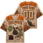 Front and back views of a Halloween-themed short-sleeve V-neck jersey. The jersey features orange and beige flames, skulls, bats, and spooky illustrations of pumpkins and a haunted castle.