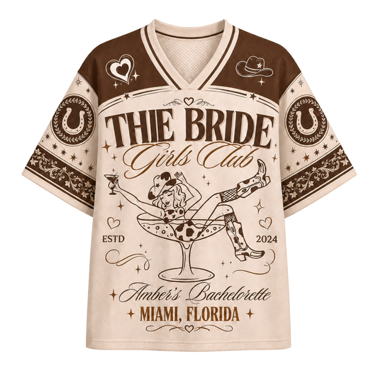 A short-sleeve V-neck t-shirt with a detailed bachelorette graphic. The shirt features a cream-colored body with red shoulders and sleeves, decorated with celestial and ornamental patterns.