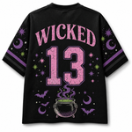 A cream-colored V-neck athletic jersey with orange and black trim, featuring a large graphic of Frankenstein's monster holding a pumpkin cup, surrounded by autumn leaves, pumpkins, stars, and bows.