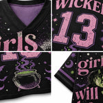 A close-up collage of a black V-neck jersey or apparel panel with a witch-themed graphic print. The design includes pink cracked text reading 'Wicked' and 'girls will', a large pink number 13, purple crescent moons and stars, a cauldron with green potion, bats, and a witch illustration.