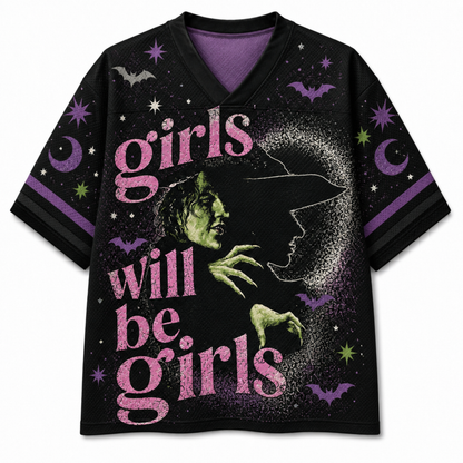 A black mesh V-neck jersey shown from the front and back, decorated with a colorful Halloween theme. The front features a central graphic of a creepy doll character in a knit hat and scarf holding a drink and a cookie, surrounded by pumpkins, bows, and stars.